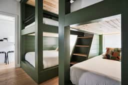 Stylish 3-Bed Retreat, Rooftop, Parking, Sleeps 10  |  Ensuite Baths, Bunk Room, Gourmet Kitchen, Cozy Living Space, Rooftop Views & Fire Table, Near Downtown, Distilleries & Marathon Village, 24 Hr Hospitality - Image 5