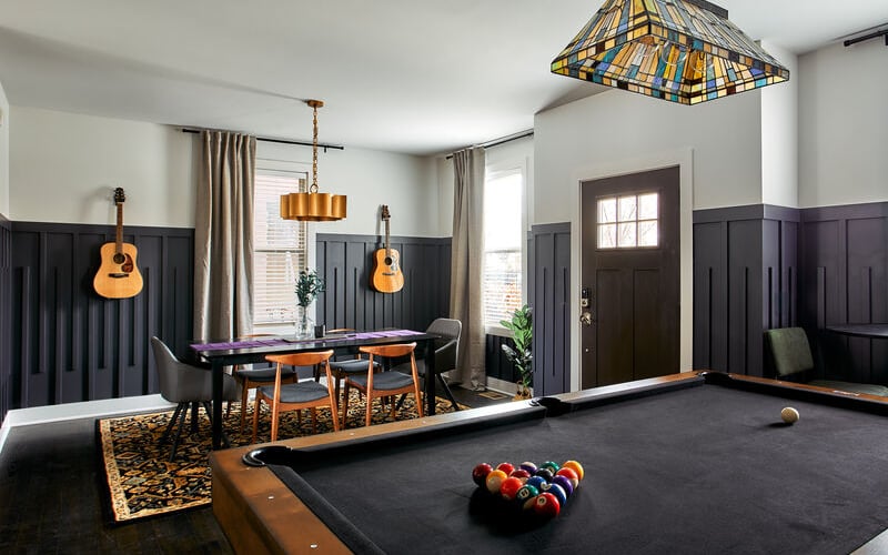 Recreation room with pool table, billiards, dining area, hanging guitars, and stained glass pendant light